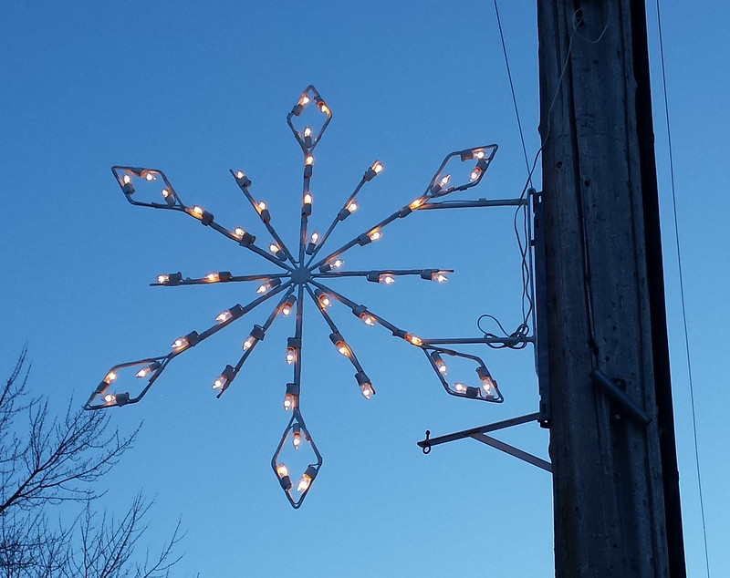 lighted snowflake at dusk