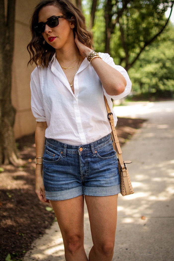 jean shorts. white button down with shorts. summer outfit. ray ban wayfarer. cross body bag.