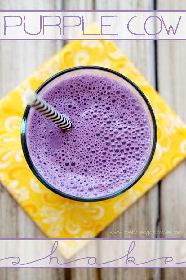 Purple Cow Shake in a glass with a straw.