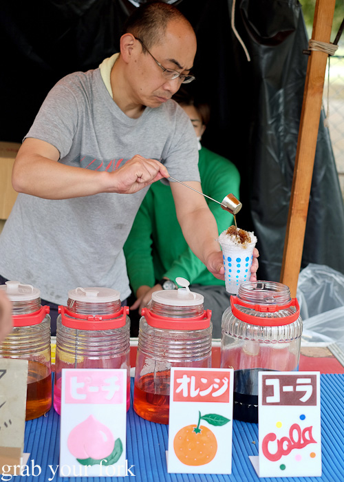 Adding cold syrup to kakigori shaved ice in Nara, Japan