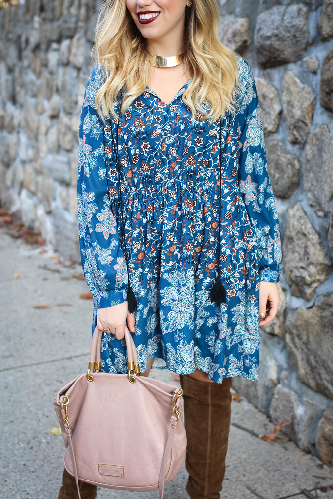 woman wearing blue Boho Thanksgiving Dress, holding a pink bag, and wearing a brown boots