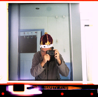 reflected self-portrait with Minolta Autopak 600-X camera and royal crown