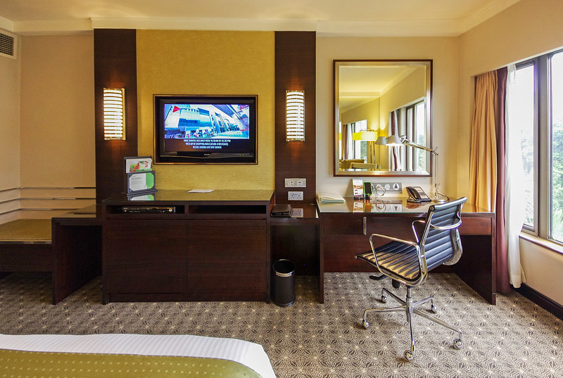 tv and work desk - club room of holiday inn singapore orchard city centre