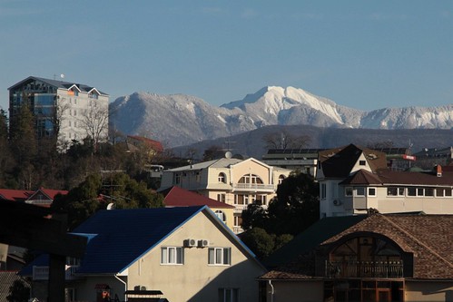 Snow covered mountains tower over the Russian city of Sochi