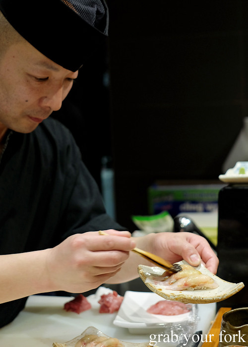 Sushi chef Tomoyuki Matsuya brushing soy sauce onto latchet at Hana Ju-Rin in Crows Nest Sydney
