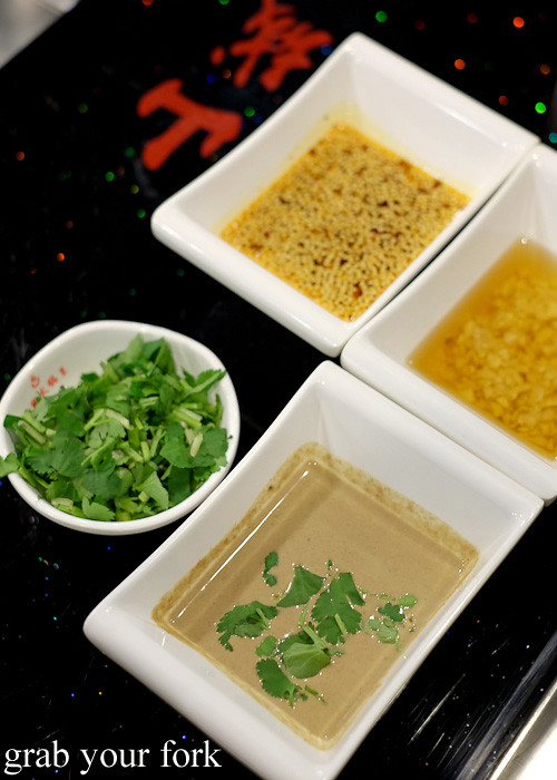 Chilli sauce, sesame oil, sesame seed paste and coriander for steamboat at Shancheng Hotpot King, Sydney