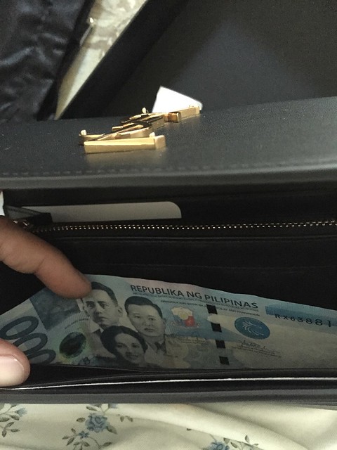 one thousand peso bill in YSL purse