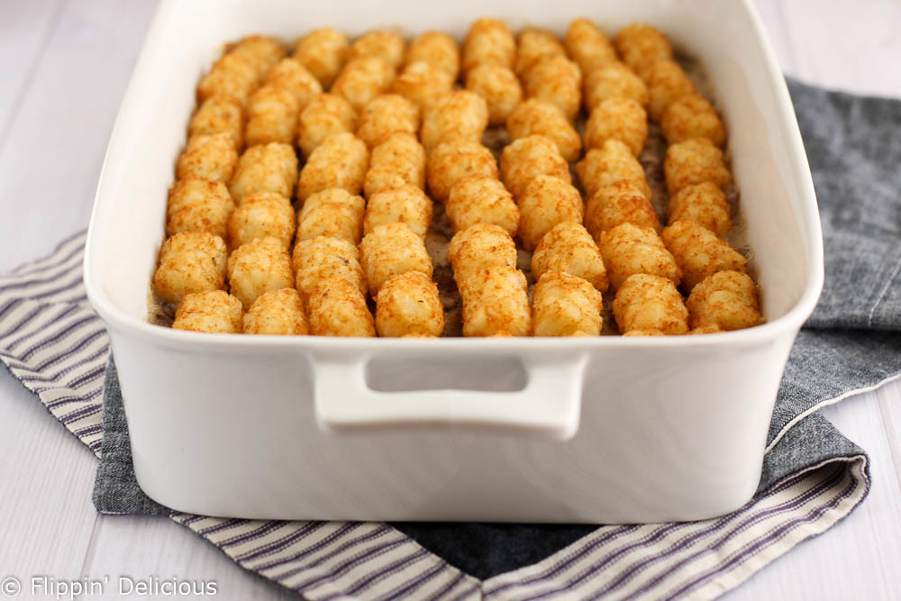 This gluten-free tater-tot casserole is comfort food at its best! Easy, creamy filling filled topped with golden tater-tots.