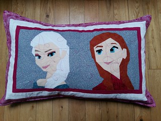 Pillow sham made with paper pieced frozen characters Anna and Elsa. Patterns on fandominstitches.