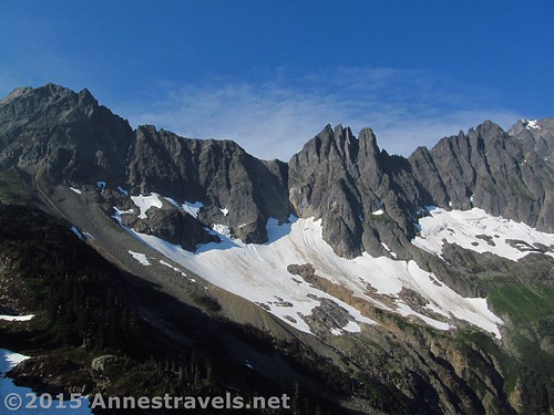 The steep cliffs of The Triad (center) as well as Cascade Peak and Johannesburg Mountain (right out of the picture) dominate the views just before reaching Cascade Pass. North Cascades National Park, Washington