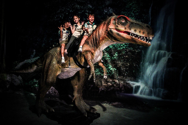 Children experiencing riding the T-rex