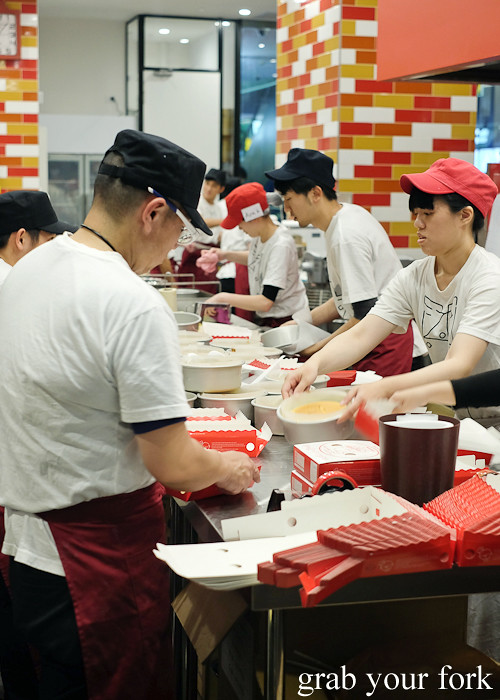 Staff making cheesecakes in the open kitchen at Uncle Tetsu's Cheesecake at Regent Place Sydney
