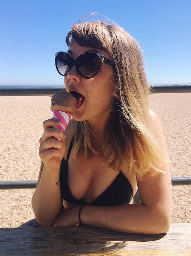 Lyzi girl in bikini licking ice cream at Blackpool Sands, Devon.