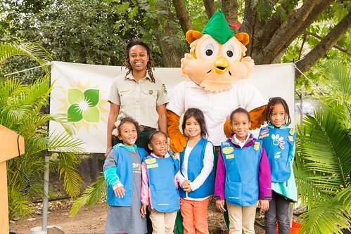 A Forest Service employee, along with Woodsy Owl, pose with kids from the Girl Scott’s Daisy program during National Public Lands Day (Photo Credit: US Forest Service.)