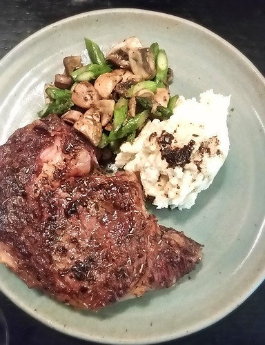 Ribeye steak au jus with goat cheese mashed potatoes and sauteed crimini and asparagus